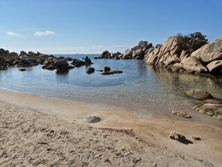 Plage de Tamaricciu, Scenic coastal view showcasing turquoise waters, rocky outcrops, and white sand at a beach in Porto Vecchio, South Corsica.