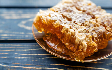 honey in honeycombs on a brown wooden background
