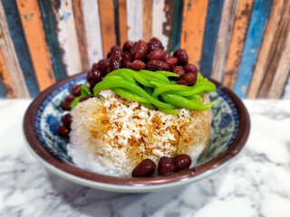 Cendol is a Malaysian dessert made of shaved ice, coconut milk, green pandan jelly noodles, and sweet dark brown sugar syrup. 