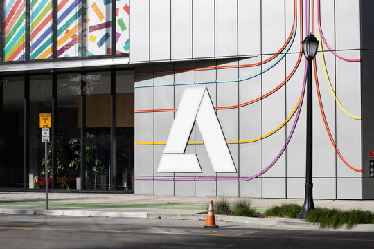 San Jose, CA, USA - Nov 28, 2024: Adobe logo is seen outside of the Founders Tower, a new all-electric building powered by renewable energy, at the company's headquarters in San Jose, California.