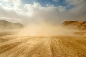 Desert dust storm blowing across sandy road