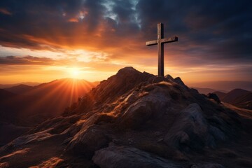 Majestic scenery of a wooden cross standing on a mountain peak, illuminated by the warm glow of the setting sun