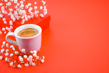 Composition for the holiday of Valentine's Day, March 8, holiday. Gift box with a cup of coffee and...