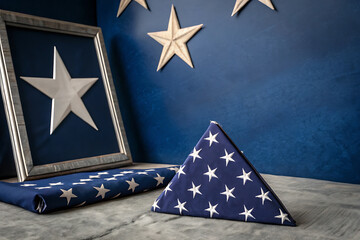 Military appreciation month tribute with folded american flag and stars decor.