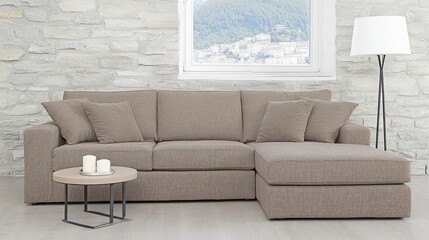 Modern beige sectional sofa in contemporary living room with stone wall and window view.