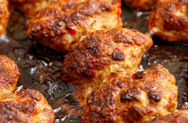 A pan of meat is cooked and has a burnt crust