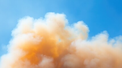 Vibrant orange and yellow smoke against a blue sky