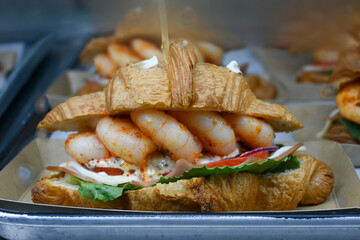 a sandwich full of shrimp and vegetables