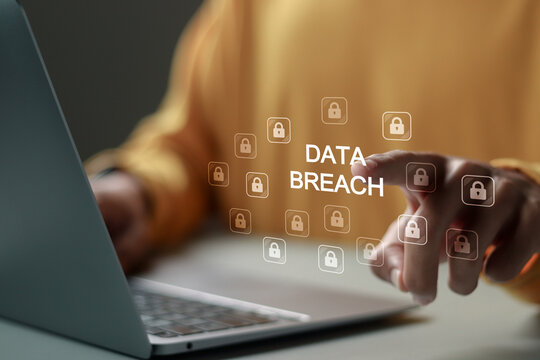 Data breach and hacker attack concept. Person use laptop with Data breach word and padlock icon for information leak. data protection, firewalls, privacy measures, and access information.