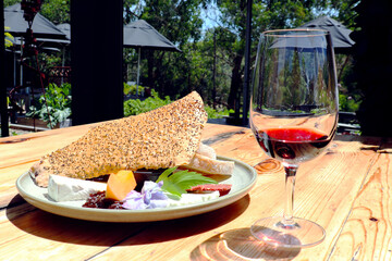 glass of red wine and cheese plate