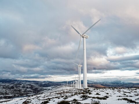 Wind turbines on snowy mountain landscape