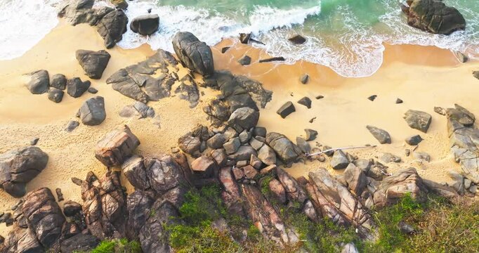 Aerial view top view of sandy beach in the golden morning sun light