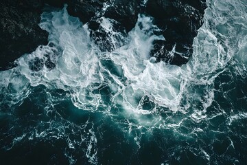 Fototapeta premium Aerial view of ocean waves crashing on rocks, background texture