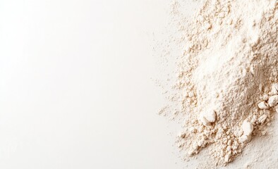 Wheat flour and grains on white, showcasing a pile of flour with an ear of wheat beside it, natural agricultural elements. Bakery ingredient