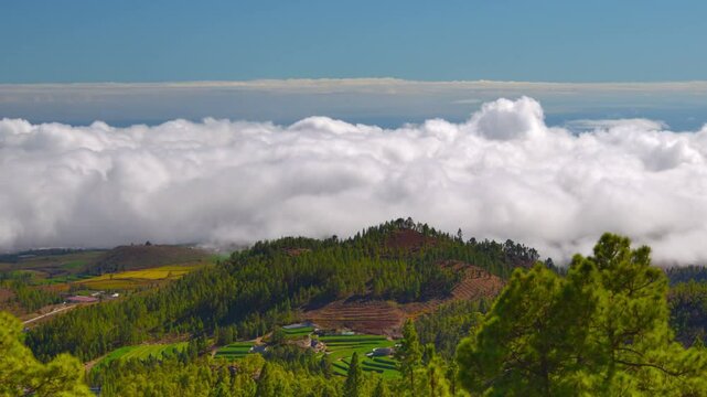Flow of clouds rolling over mountains landscape time-lapse