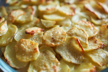 Fried potatoes in a baking dish. Selective focus. 