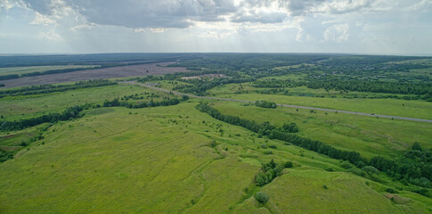 Large field of grass with a few trees in the background