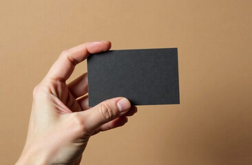Male hand with black business card on background. Free space