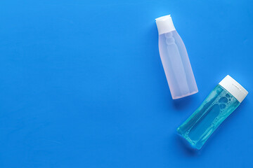 Organic cosmetics for face clearing with facial tonic and mycelial water on blue background top view copy space