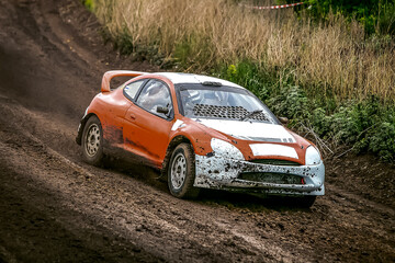 Rally car racing on dirty road