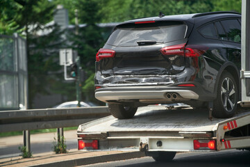 Car accident recovery with tow truck in street