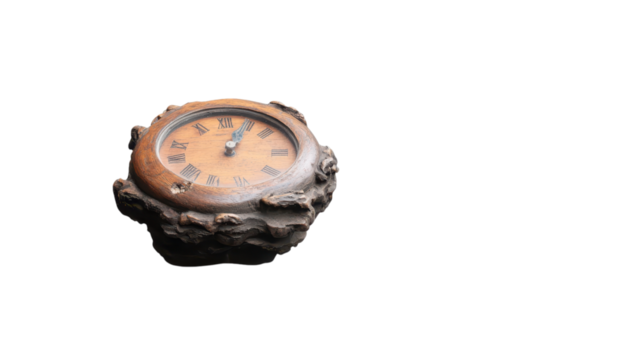 Antique clock with a decorative base on a black background.