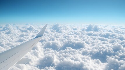 Obraz premium Aerial View of Airplane Wing Soaring Above Fluffy Clouds and Clear Blue Sky