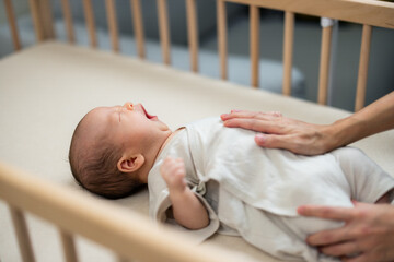 Mum massage on baby tummy at home