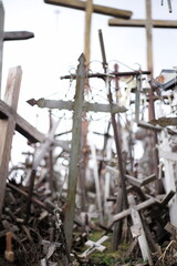 Thousands of religious symbols, crucifixes, rosaries, rosary and catholic crosses with Jesus, Hill of Crosses, Kryžių kalnas,  is a site of pilgrimage north of of Šiauliai, Lithuania