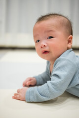 Fototapeta premium Baby crawling on mat indoors