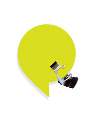 Conceptual graphic design. Overhead view of person working on laptop inside yellow speech bubble,...