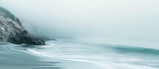 Fototapeta premium Misty shoreline view at a beach. with copy space image. Place for adding text or design