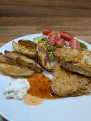 grilled chicken breast, potatoes and vegetable