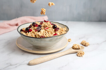 A nutritious bowl of oatmeal muesli with crunchy nuts and dried fruits, for a breakfast.