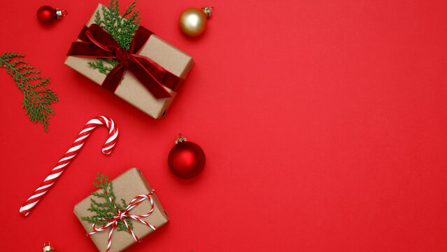 Christmas ornaments,  gifts wrapped in craft paper, thuja branches, candy cane