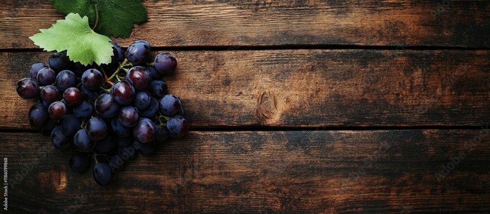 Aufkleber Bunch of grapes on a rustic wooden surface Top view. with copy space image. Place for adding text or design