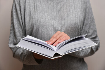 Woman read a book close up front view