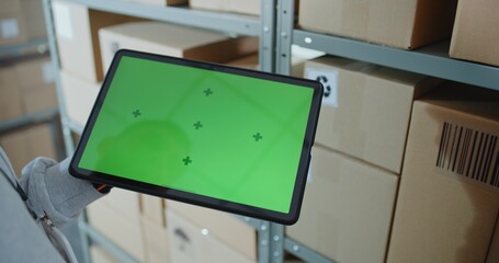Postal Warehouse Associate Scans Code on Cardboard Box with Barcode Scanner, Checks Parcel Information, Tracks Package Delivery Route. Tablet Computer Screen Shows Green Screen Chroma Key. Close Up.