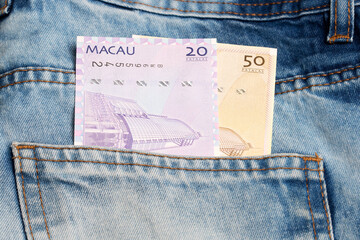 Macanese pataca in the pocket of blue jeans