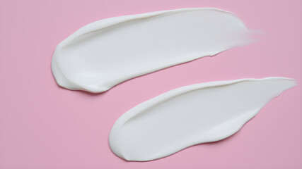 Pieces of cosmetic cream on pink background. Generative AI