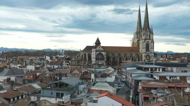 Bayonne Cathedral and cityscape, France. Aerial forward ascending, drone fliying over roofs, copy space