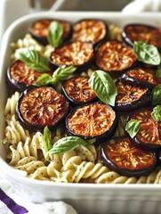 Delicious eggplant pasta salad with fresh basil leaves, served in a casserole dish. A healthy vegetarian meal option perfect for warm weather and gatherings.