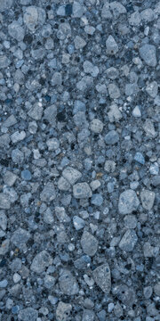 Close-up view of a textured surface made of small stones and gravel.