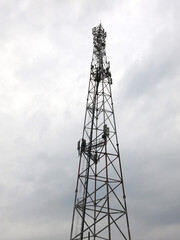 metal communications tower against a gloomy sky