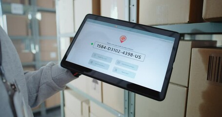 Inventory Manager Scans Code on Cardboard Box with Barcode Scanner, Checks Parcel Information. Tablet Computer Screen Shows Delivery Tracking System for Monitoring Package with Online Orders. Close Up