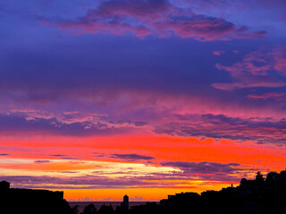 Dramatic sky clouds colorful sunset over old town