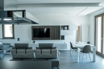 Moving to a new house. Living room interior. Large sofa and TV cabinet in a modern interior design