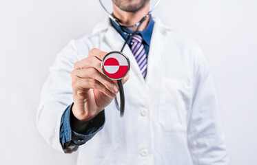 Greenland Healthcare System, doctor holding stethoscope. Greenland health and medical insurance concept
