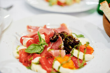 Delicious Italian Appetizer Featuring Fresh Vegetables, Mozzarella, and Flavored Garnishes..