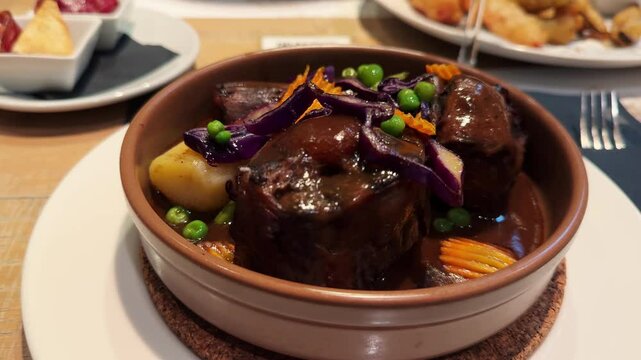 Eating traditional Spanish soup with oxtail in restaurant. . High quality 4k footage